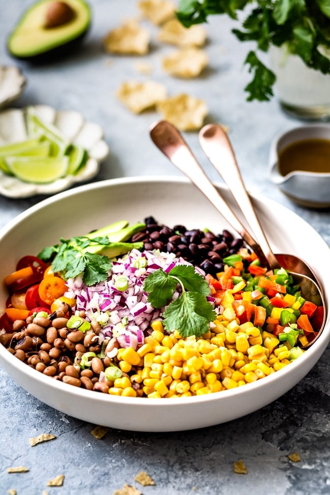 Texas Bean Salad loaded with black-eyed peas, corn, tomatoes, bell peppers, avocado, and tangy lime dressing makes the best salad, dip or side dish. 