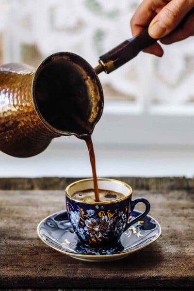 A cup of freshly brewed Turkish coffee photographed from the front view