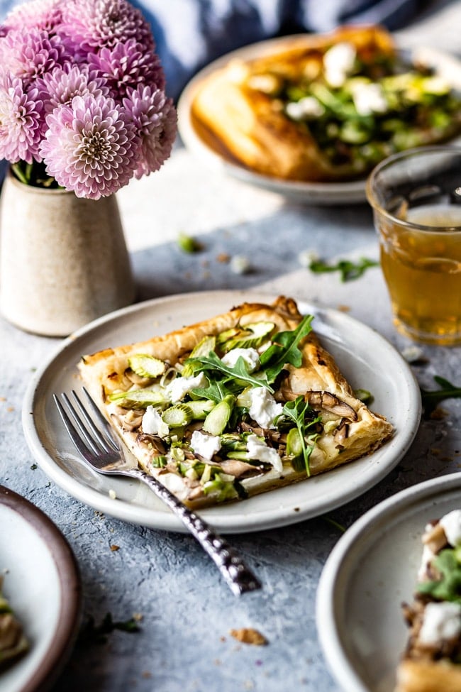 a slice of Asparagus Tart with puff pastry and goat cheese