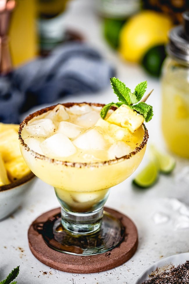 Pineapple Margarita on the rocks with mint garnish photographed from the front view.