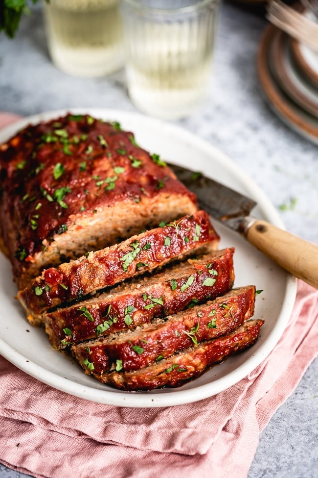 Ground Turkey meatloaf sliced and placed on a plate photographed from the close view.