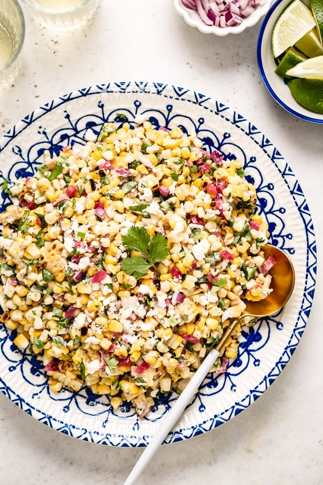 Mexican Street Corn Salad is placed in a plate and photographed from the top view.
