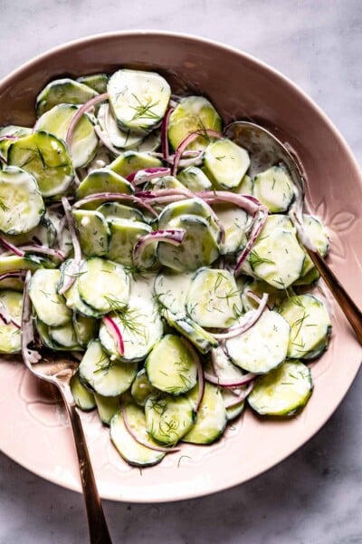Greek Yogurt Cucumber salad in a bowl with spoons on the side.