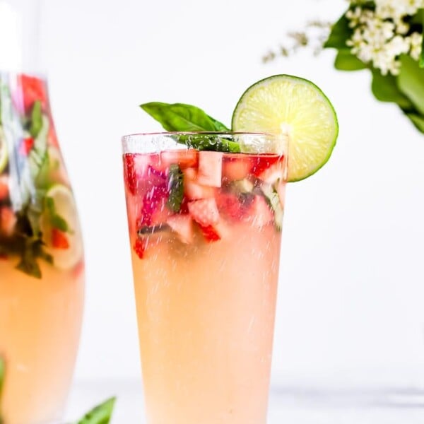 Strawberry Basil Limeade garnished with a lime slice in a glass