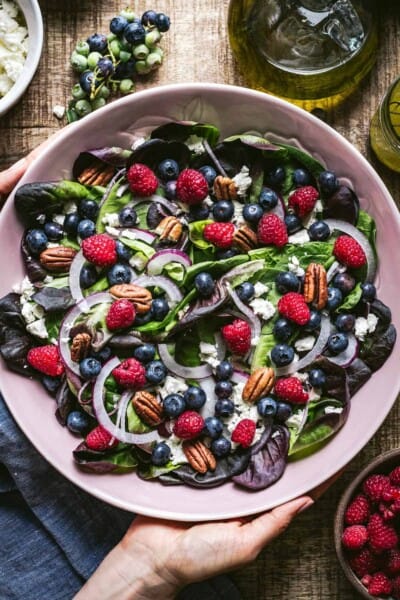Blueberry Salad recipe serve in a bowl by a person