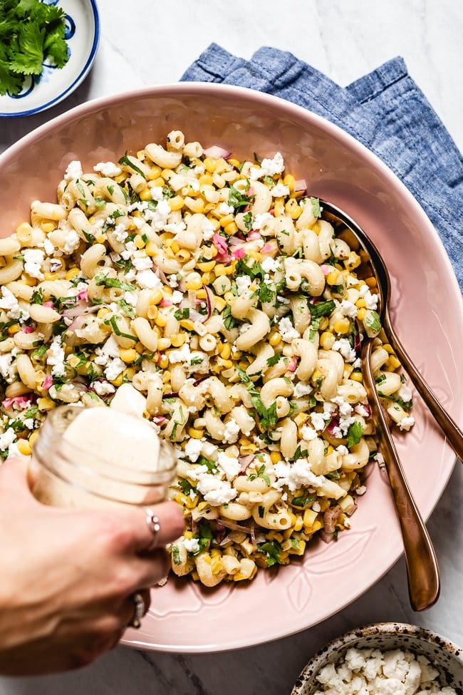 Mexican Street Corn Pasta salad is drizzled with creamy chili lime dressing photographed from the top view.