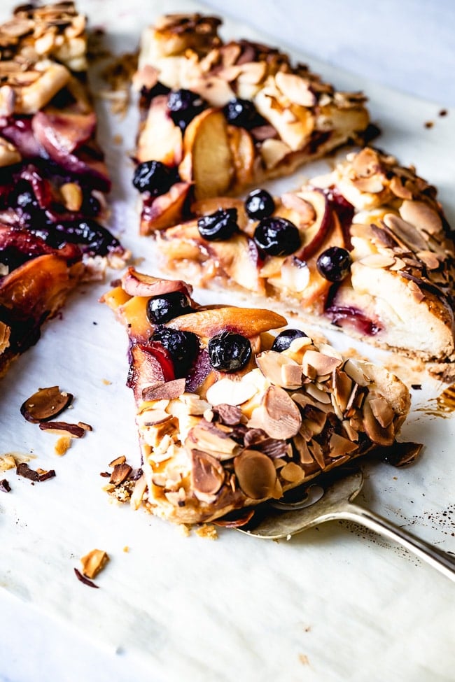 A slice of blueberry nectarine galette is photographed from the front view