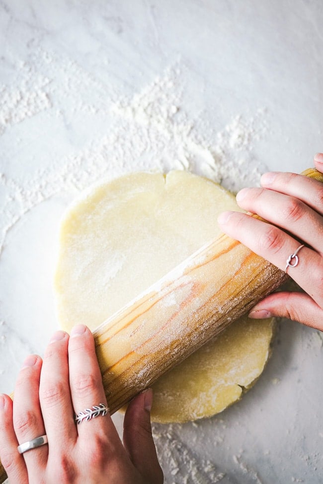 Galette pastry being rolled by a woman