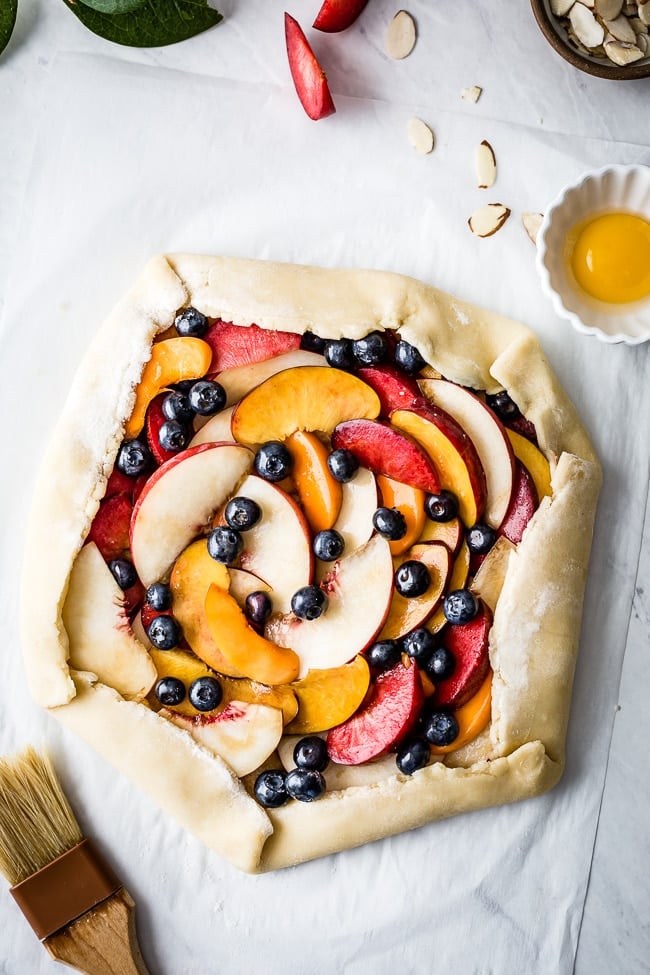 fresh peaches and blueberries wrapped up in a homemade galette crust.