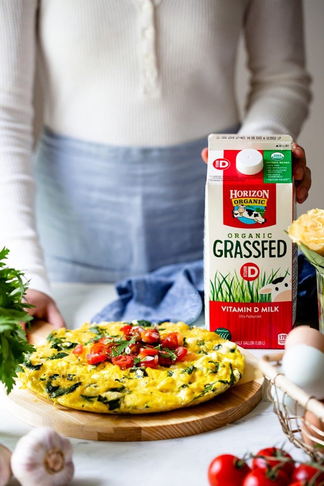 Healthy Frittata recipe photographed from the front view with a woman in the background