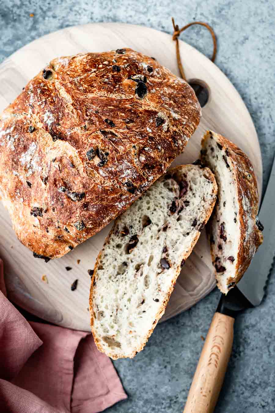 A loaf of olive bread sliced and photographed from the top view