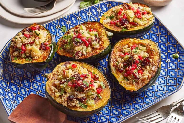 Vegan and gluten free quinoa stuffed acorn squash on a plate.