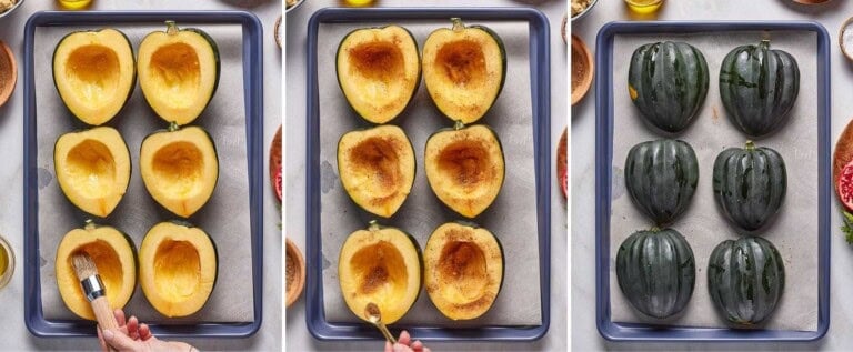 Acorn squash halves getting seasoned and roasted on a sheet pan.