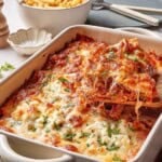 Baked ziti with meat sauce in a casserole dish.