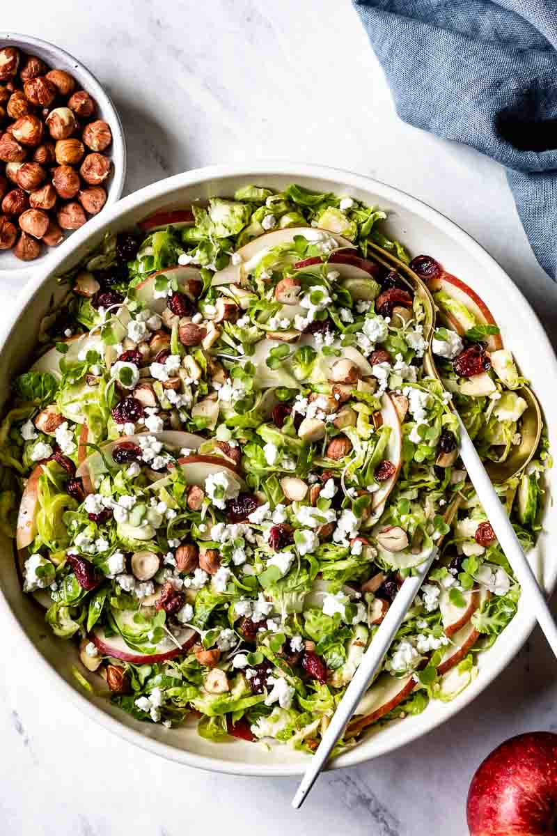 Salad made with apples and goat cheese in a bowl