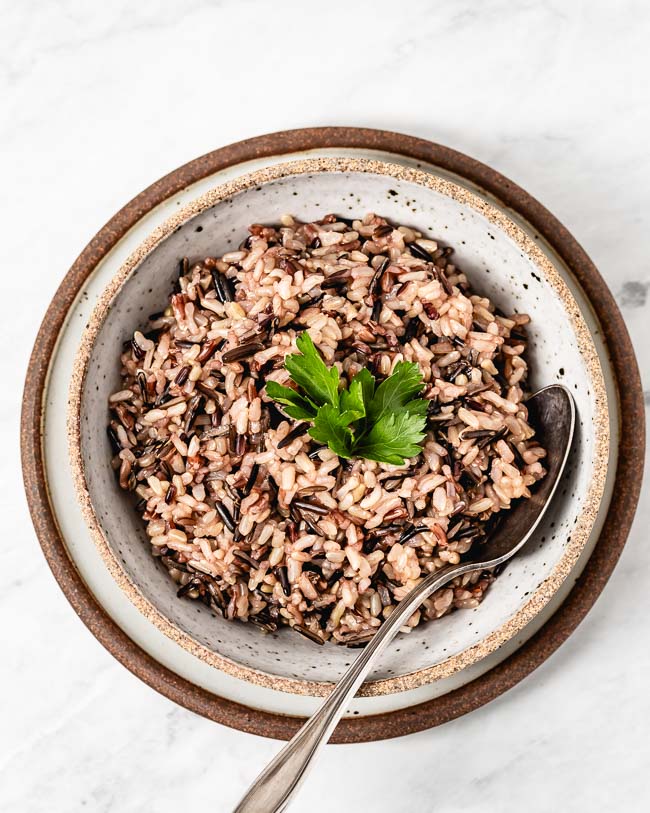 A big bowl of Instant Pot (Pressure Cooker) Wild Rice Blend is photographed from the top view.