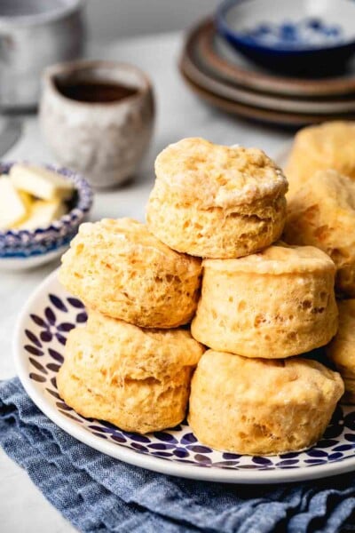 Sweet Potato Biscuits Recipe - Biscuits are placed on a plate on top of each other with butter in the background