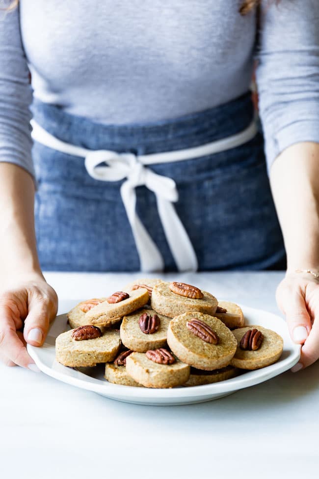 A woman is photographed as she is serving pecan shortbread cookies recipe