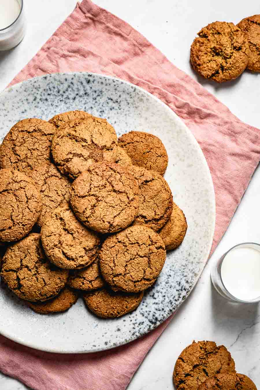 The Best Gluten-Free Gingerbread Cookies made with almond flour served with a few glasses of milk. 