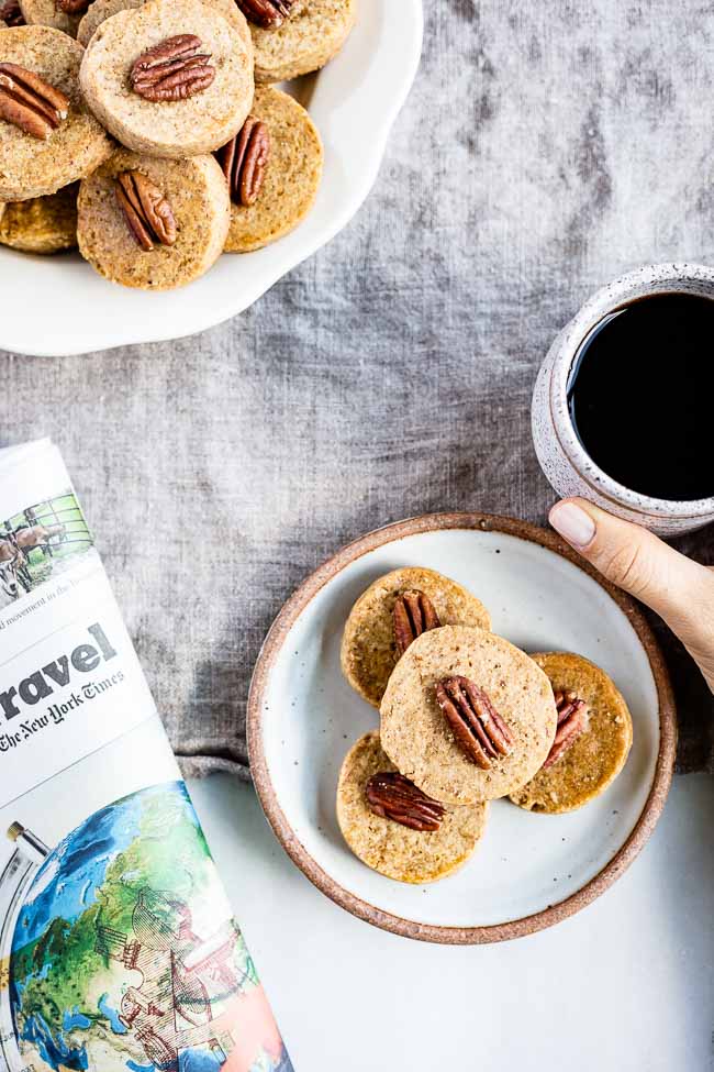 Pecan nut cookies served with coffee on the side. 