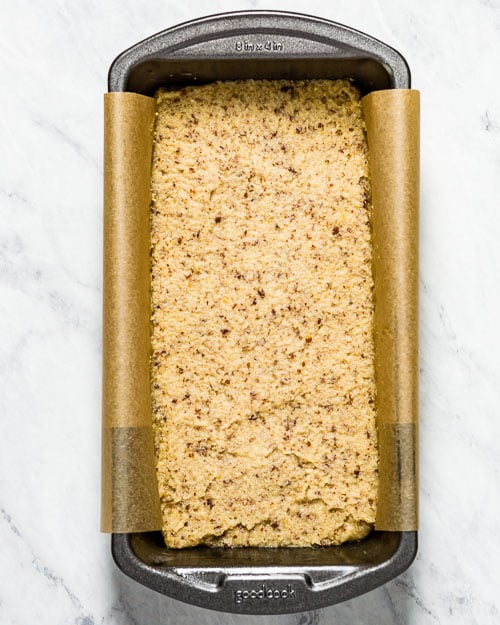 homemade low carb bread batter is placed in a loaf pan and photographed from the top view.