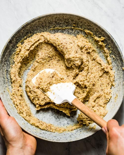 The batter is photographed while a woman is mixing it.