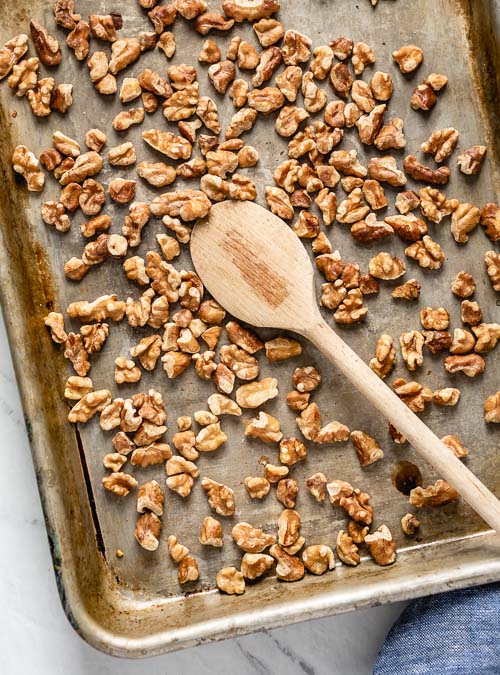 Walnuts are roasted in a baking sheet
