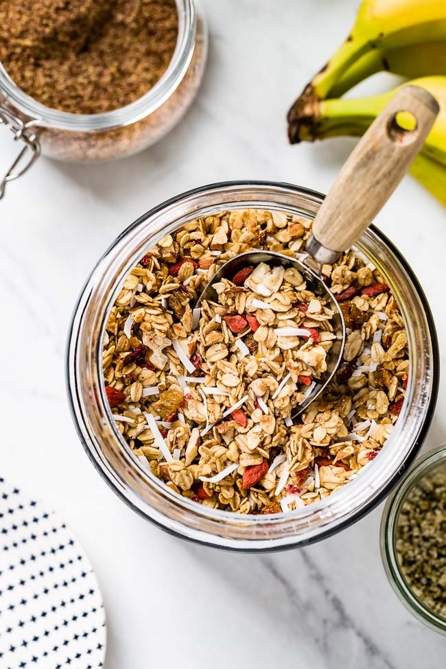 A jar filled with homemade chunky granola recipe photographed from the top view.