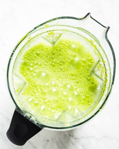 Green smoothie with turmeric blended and photographed from the top view