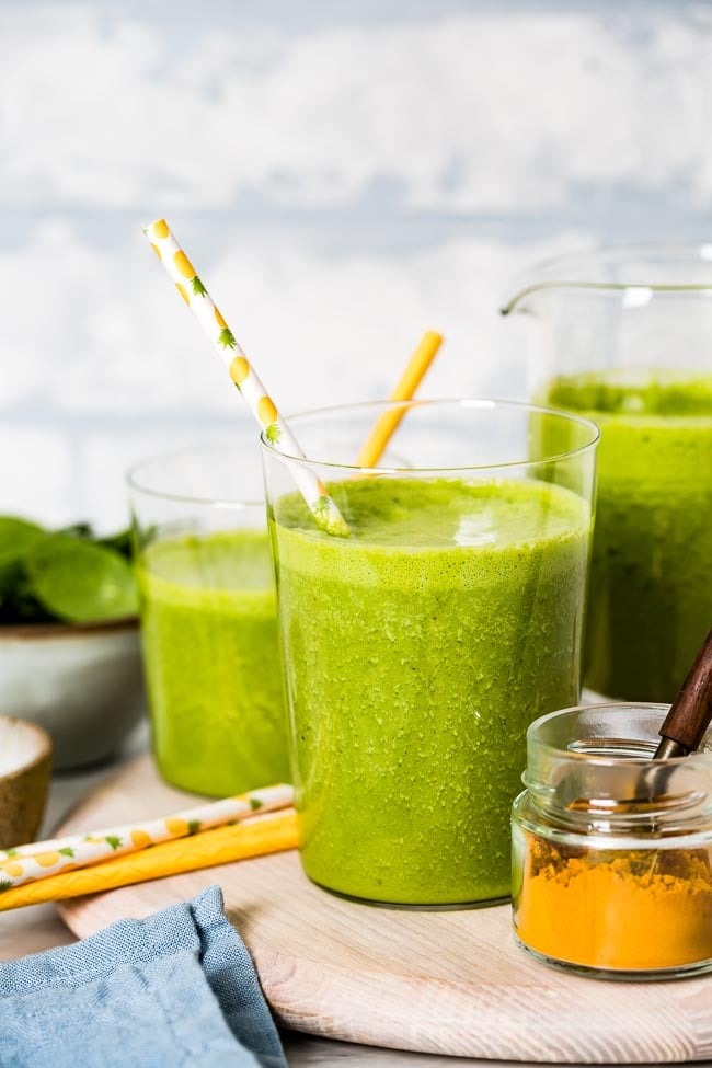 Green Turmeric Smoothie placed in glasses and photographed from the front view.