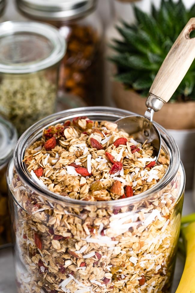 Healthy Granola Recipe with Clusters photographed in a glass jar from the front view