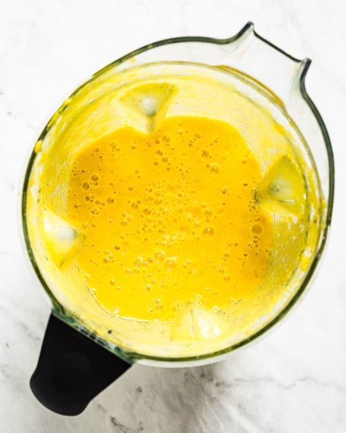 Blended Mango Turmeric Smoothie photographed from the top view.