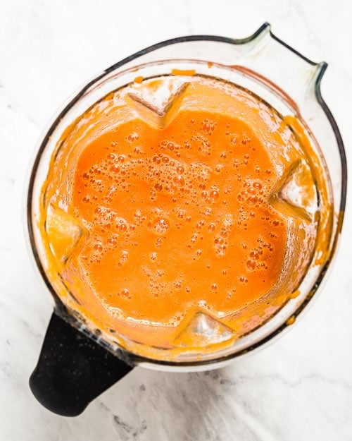Tumeric Ginger Smoothie is photographed after all of the ingredients are blended in a blender from the top view.