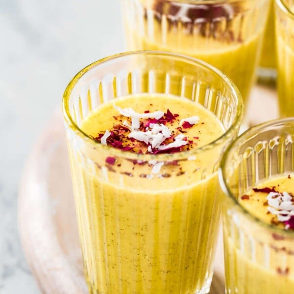 a glass of mango turmeric smoothie from the front