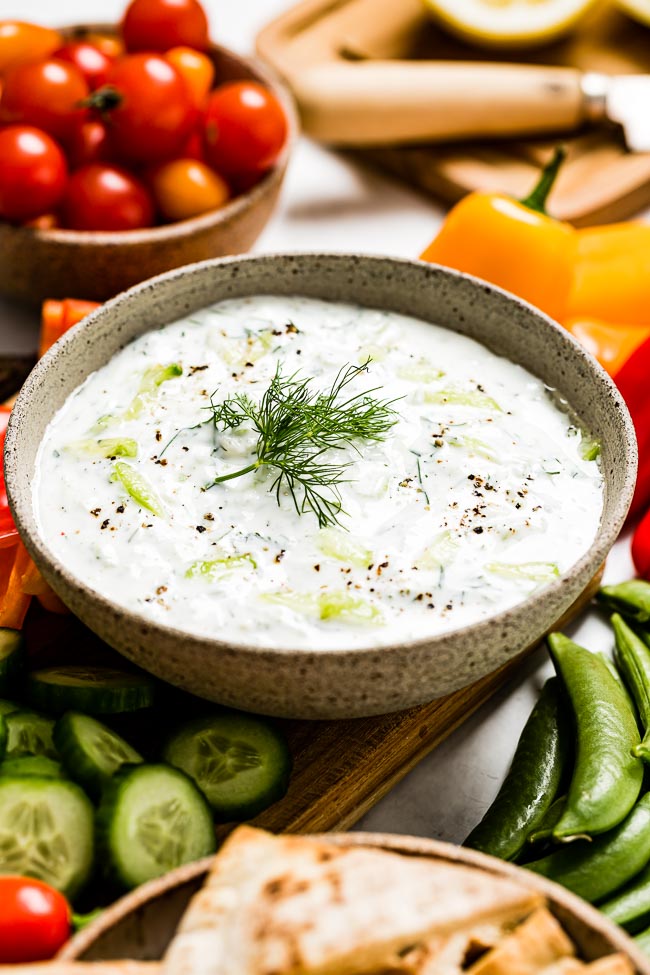 A bowl of Turkish cacik is served with fresh vegetables