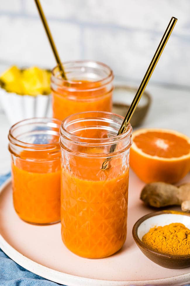 Carrot based turmeric ginger smoothie photographed from the front view.