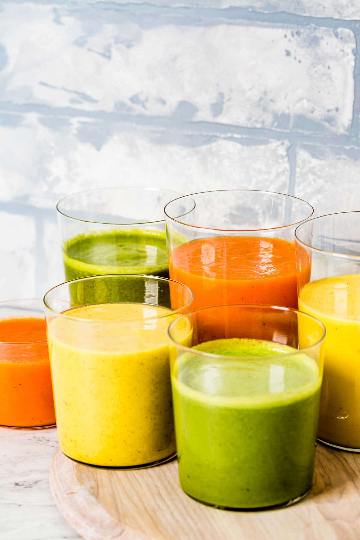 Turmeric smoothie recipes are placed in glasses and photographed from the front view.