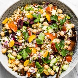 A bowl of quinoa Mediterranean salad with chickpeas and feta from the top view.