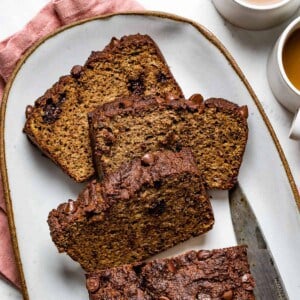 Almond flour banana bread sliced on a plate with coffee on the side