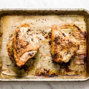 A woman is serving freshly roasted Baked Bone In Chicken Breast Recipe