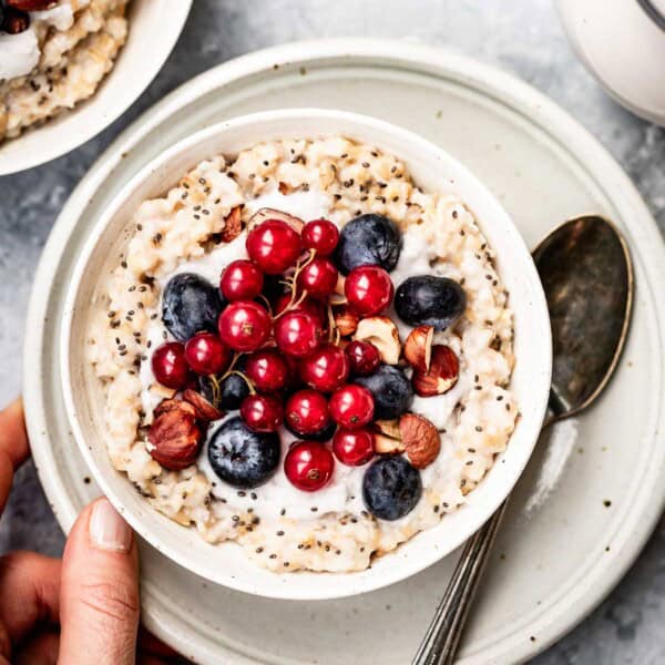 Overnight steel cut oats in a bowl topped off with fruit.