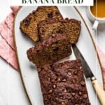 Banana bread with almond flour sliced on a plate with text of the name of the recipe on the image.