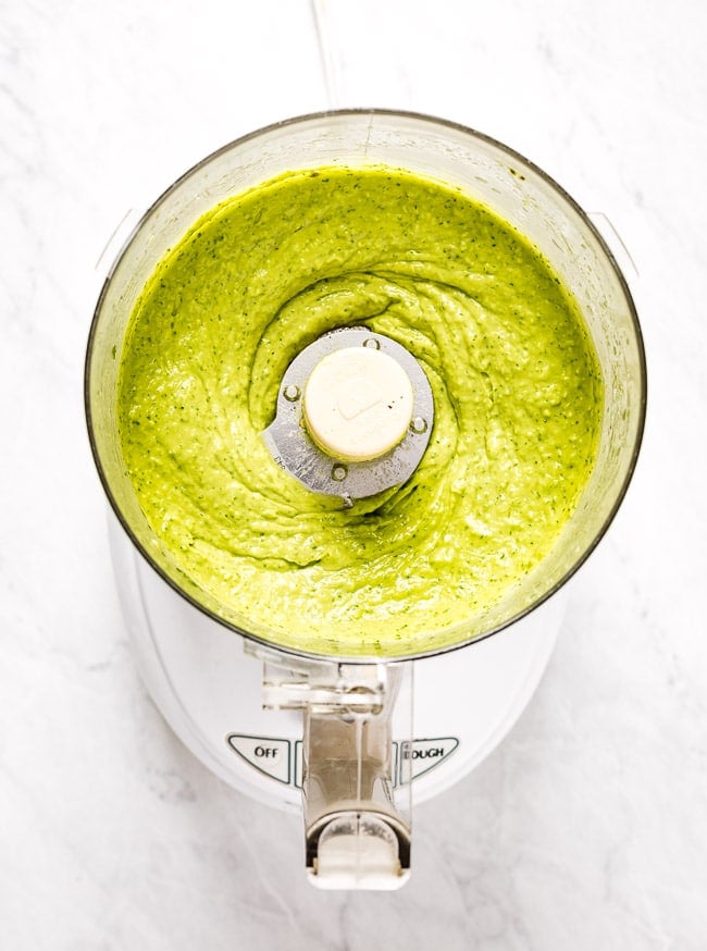 Creamy Avocado cilantro lime dressing is in a food processor