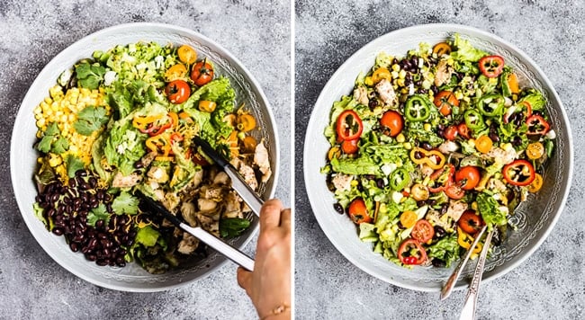 A woman is mixing salad ingredients