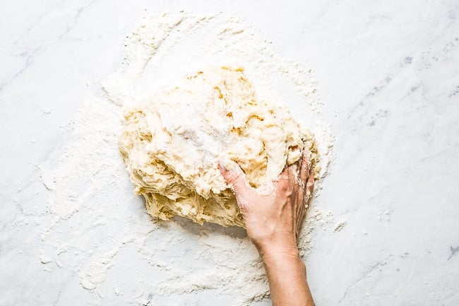 person kneading the dough