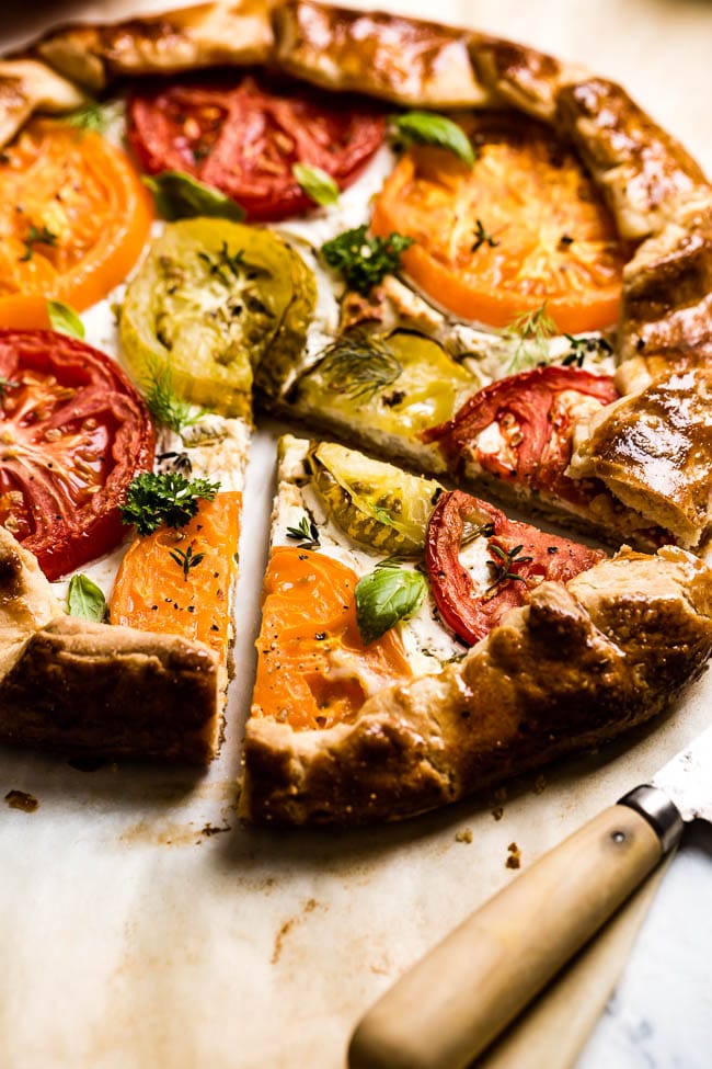 Fresh Tomato Galette Sliced with a knife on the side from the front view