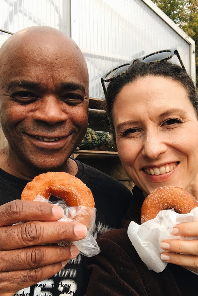 Aysegul and Dwight eating apple cider donuts in Manchester Vermont