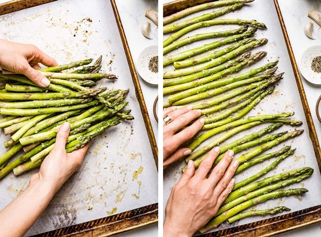 Person tossing asparagus to make sure it is fully coated and in one single layer on sheet pan