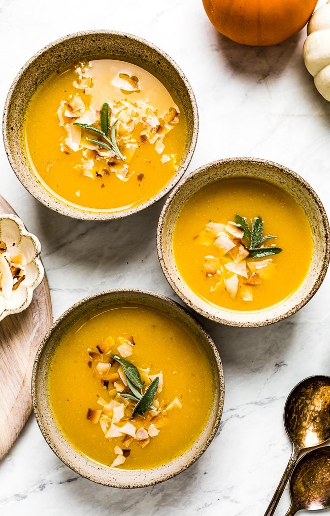 Pumpkin Ginger Soup in bowls with sage on top