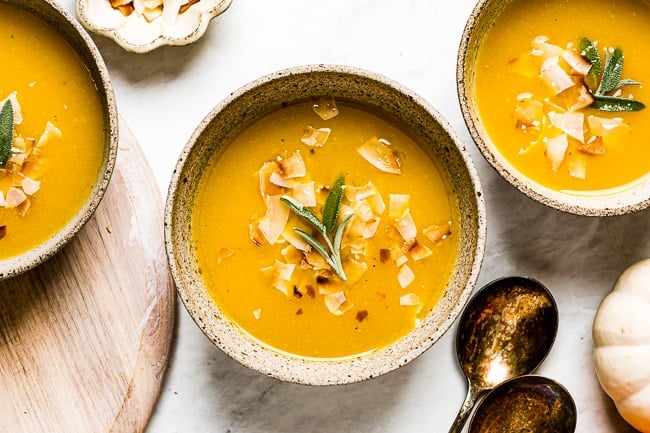 Pumpkin Soup with ginger garnished with sage in a bowl